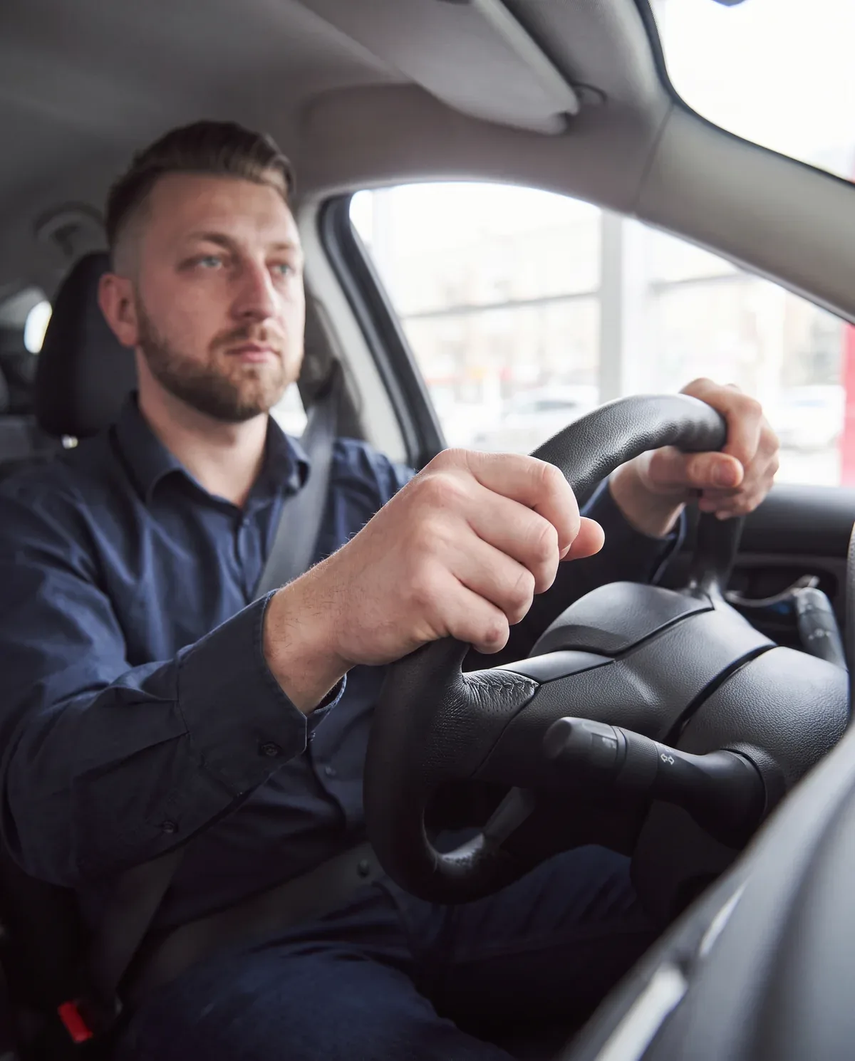 A driving instructor at the wheel of a car